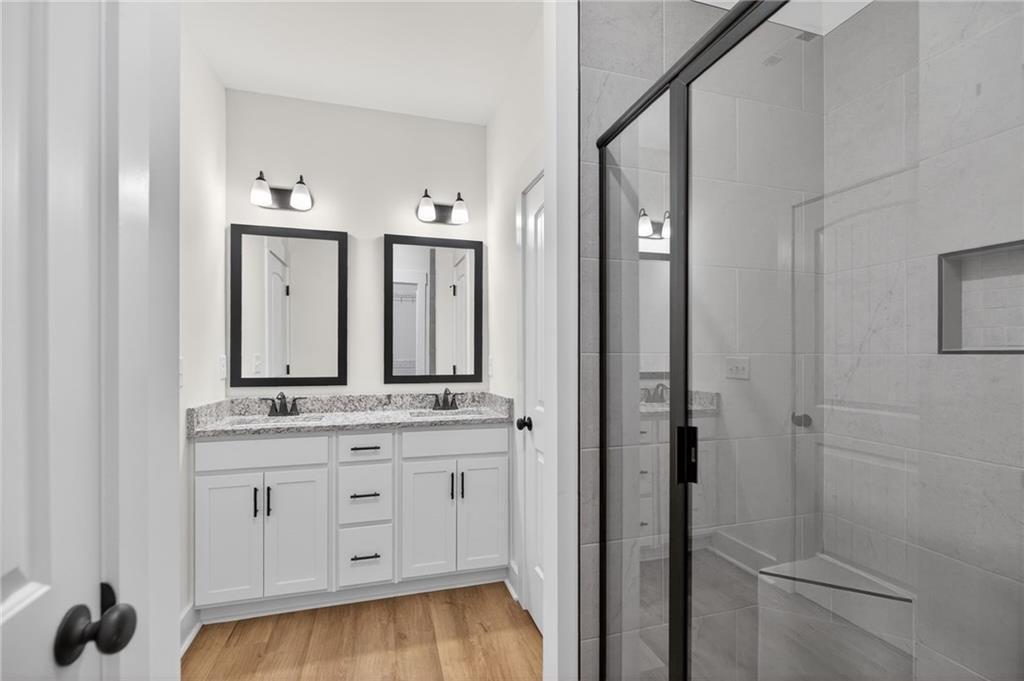 3512 Vinson Mountain Road Rockmart, GA 30153 - Photo 32 of 49 a bathroom with a double vanity sink and mirror with shower