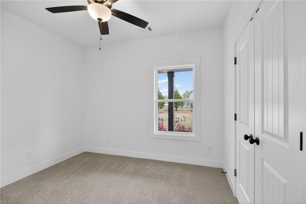 3512 Vinson Mountain Road Rockmart, GA 30153 - Photo 34 of 49 an empty room with windows and fan