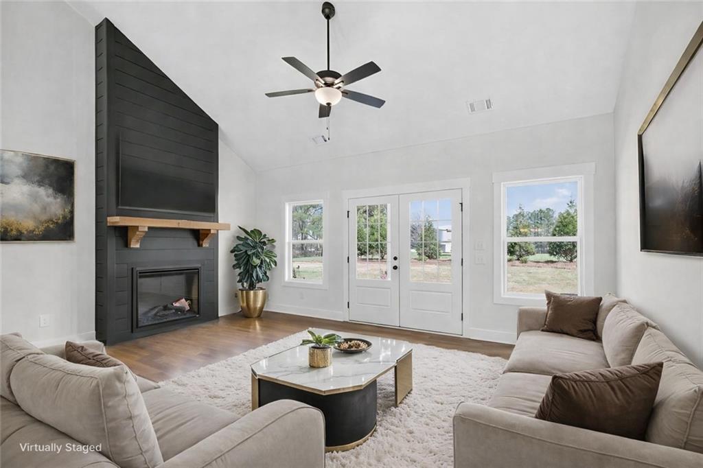 3512 Vinson Mountain Road Rockmart, GA 30153 - Photo 8 of 49 a living room with furniture a fireplace and a flat screen tv