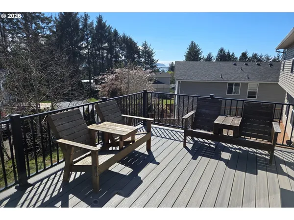 a view of a roof deck with table and chairs a barbeque with wooden floor