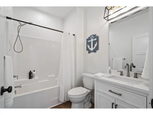 a bathroom with a granite countertop sink a toilet and a bathtub