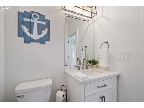 a bathroom with a sink mirror and vanity