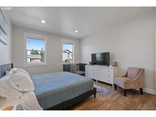 a bedroom with a bed and a television