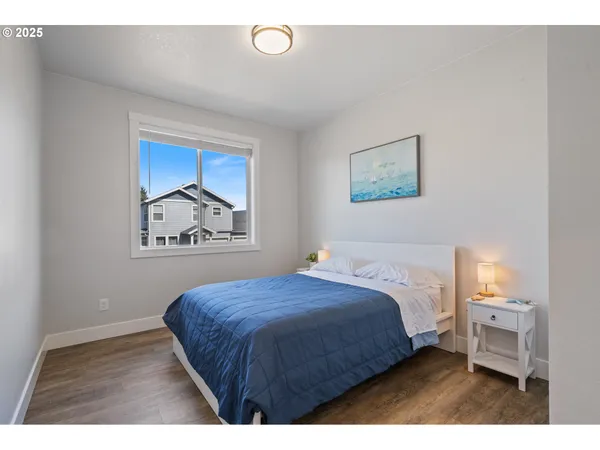 a bedroom with a bed and a painting on the wall