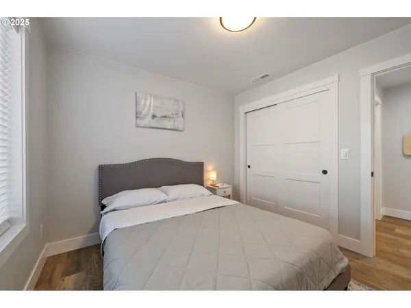 a bedroom with a bed and a night stand