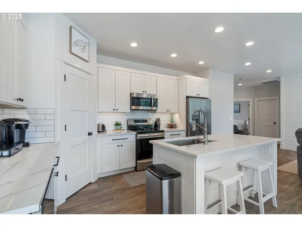 a kitchen with cabinets a sink and appliances