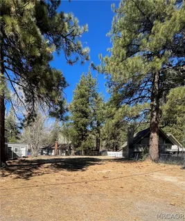 a view of a yard covered with snow in front of house
