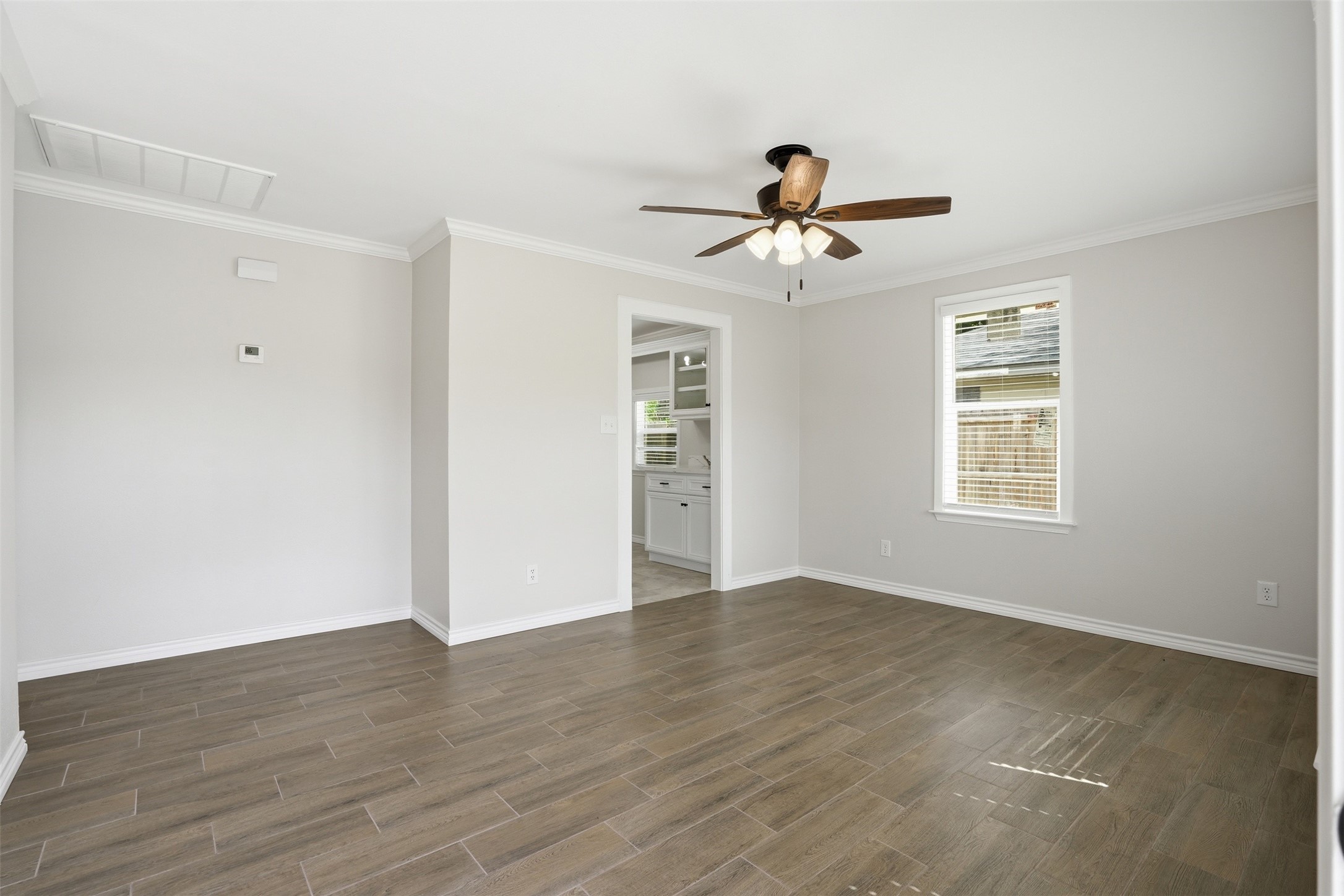 6518 Paris Street Houston, TX 77021 - Photo 9 of 23 a view of a room with wooden floor and ceiling fan