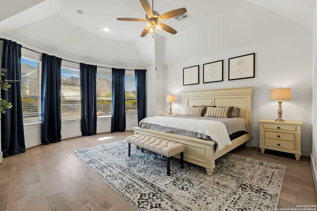 a bedroom with a large bed and a chandelier
