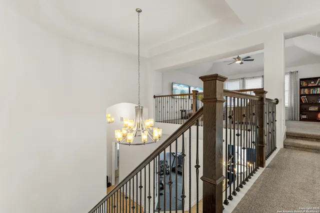 a view of staircase with railing and white walls