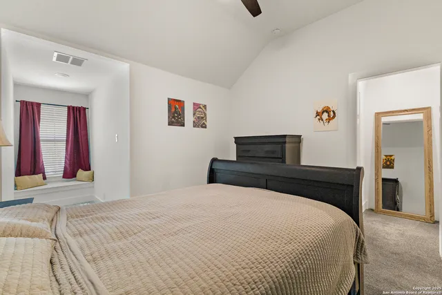 a bedroom with a bed and a television