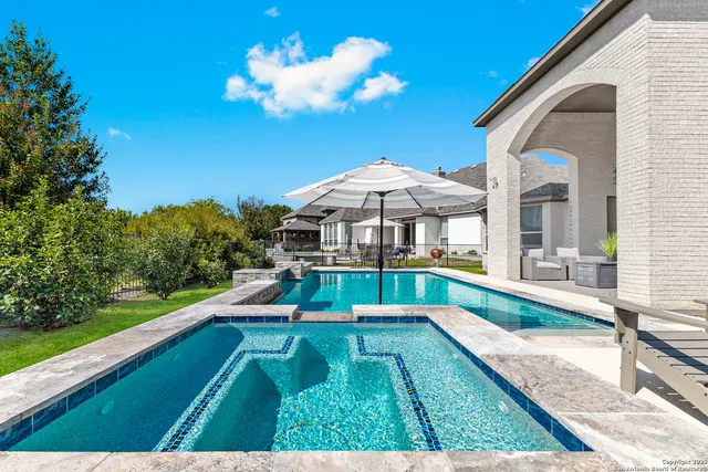 a view of an house with swimming pool having patio