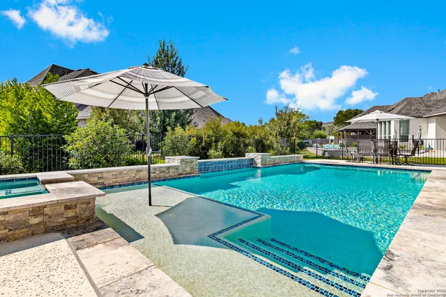 a view of a backyard with a patio and fire pit