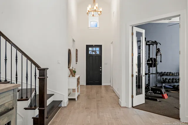 a view of a hallway with wooden floor and stairs