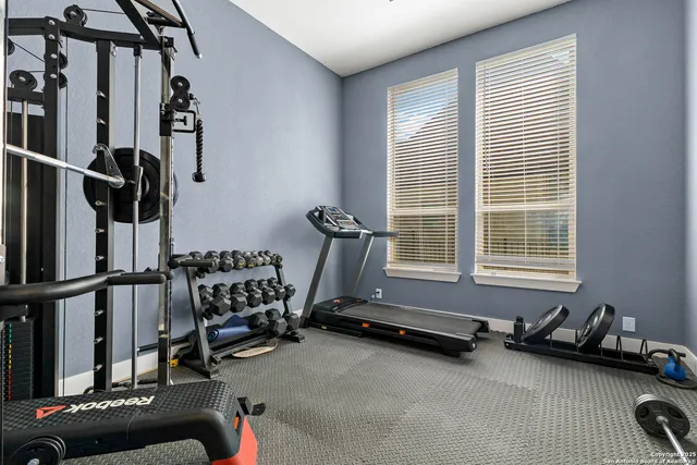 a room with gym equipment and a window