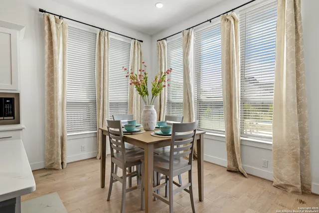 a dining room with furniture and window