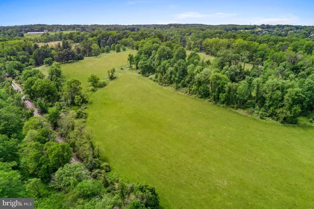 a view of a lake and green valley