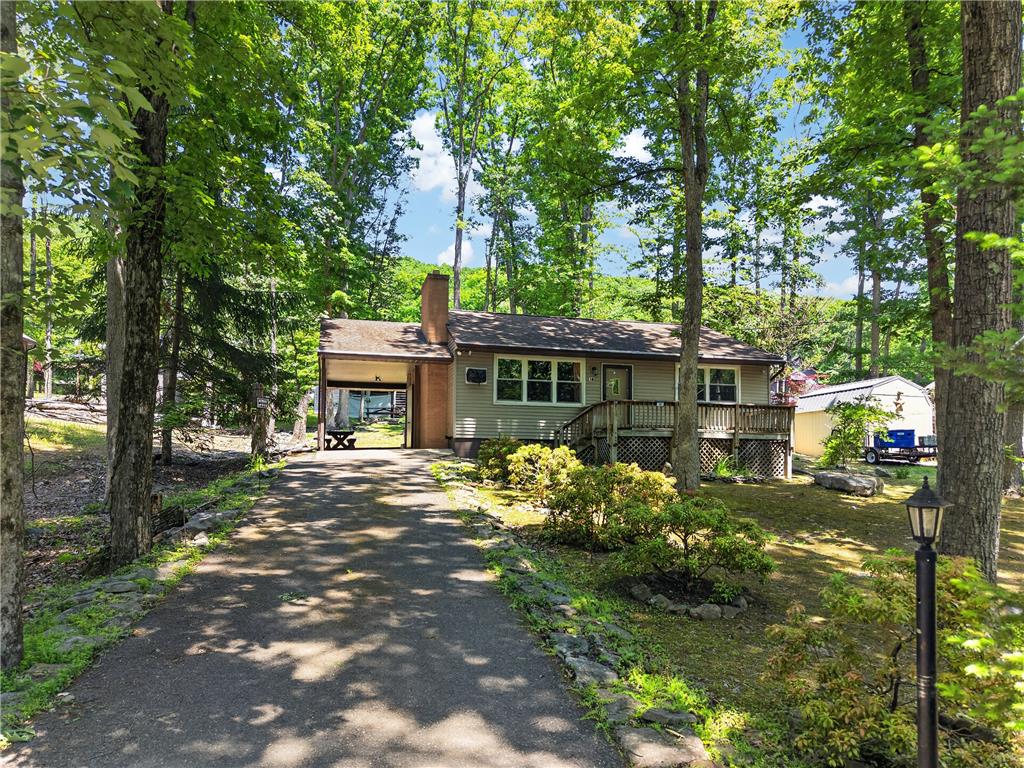 18 White Oak Road Nesquehoning, PA 18240 - Photo 4 of 52 A welcoming front exterior set amidst a verdant landscape with mature trees and a private driveway.