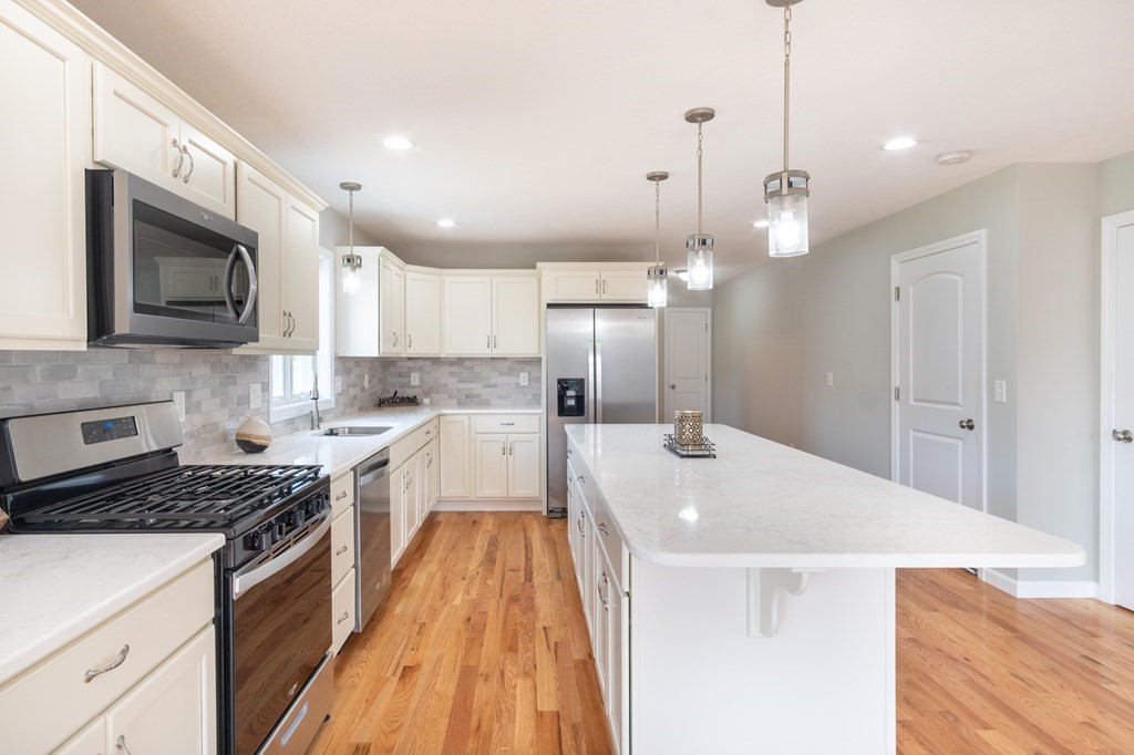 6 Upper Palmer Road Monson, MA 01057 - Photo 3 of 36 a kitchen with a stove a sink and a microwave