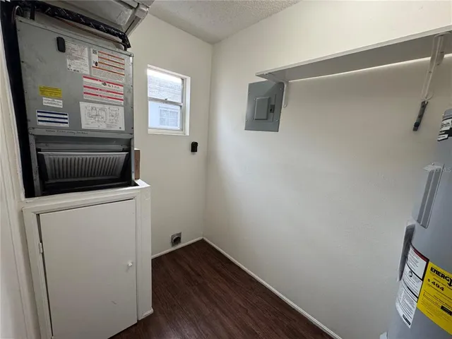 a view of storage and utility room with wooden floor