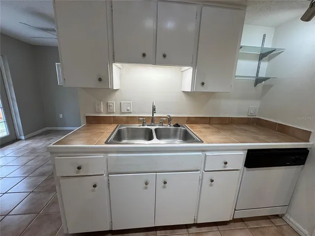 a kitchen with cabinets and white appliances