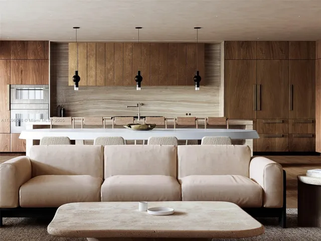 a living room with furniture and a kitchen view