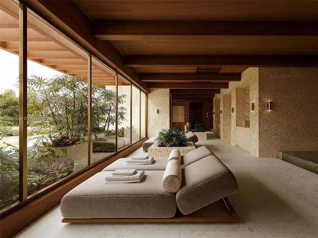 a balcony with furniture and large windows