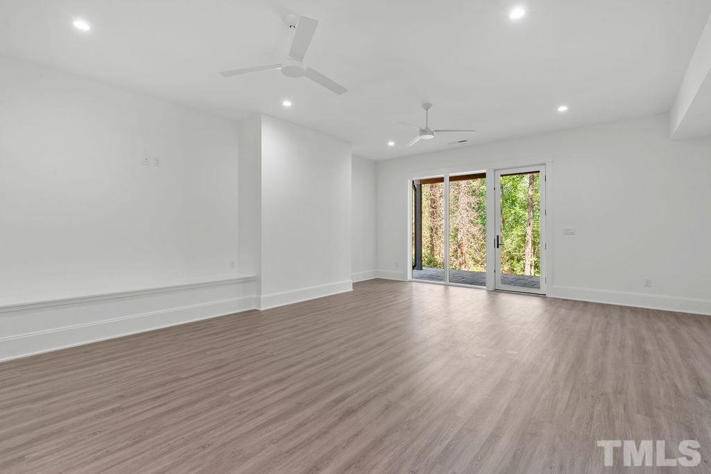 1623 Nottingham Road Raleigh, NC 27607 - Photo 11 of 29 an empty room with wooden floor and windows