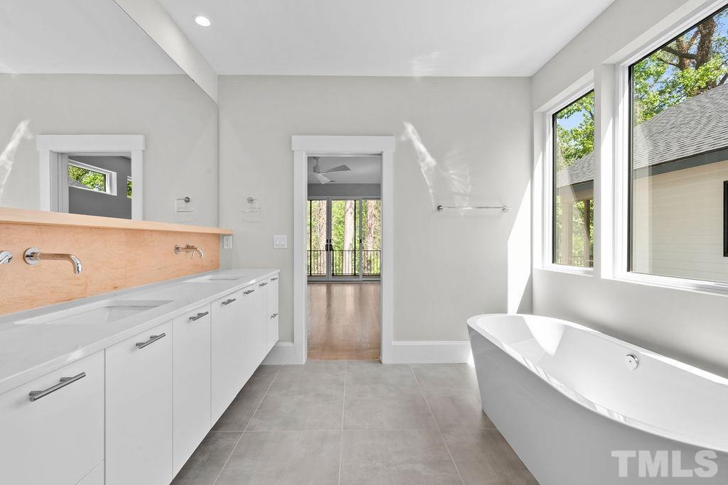 1623 Nottingham Road Raleigh, NC 27607 - Photo 18 of 29 a spacious bathroom with a tub 2 sink and a window