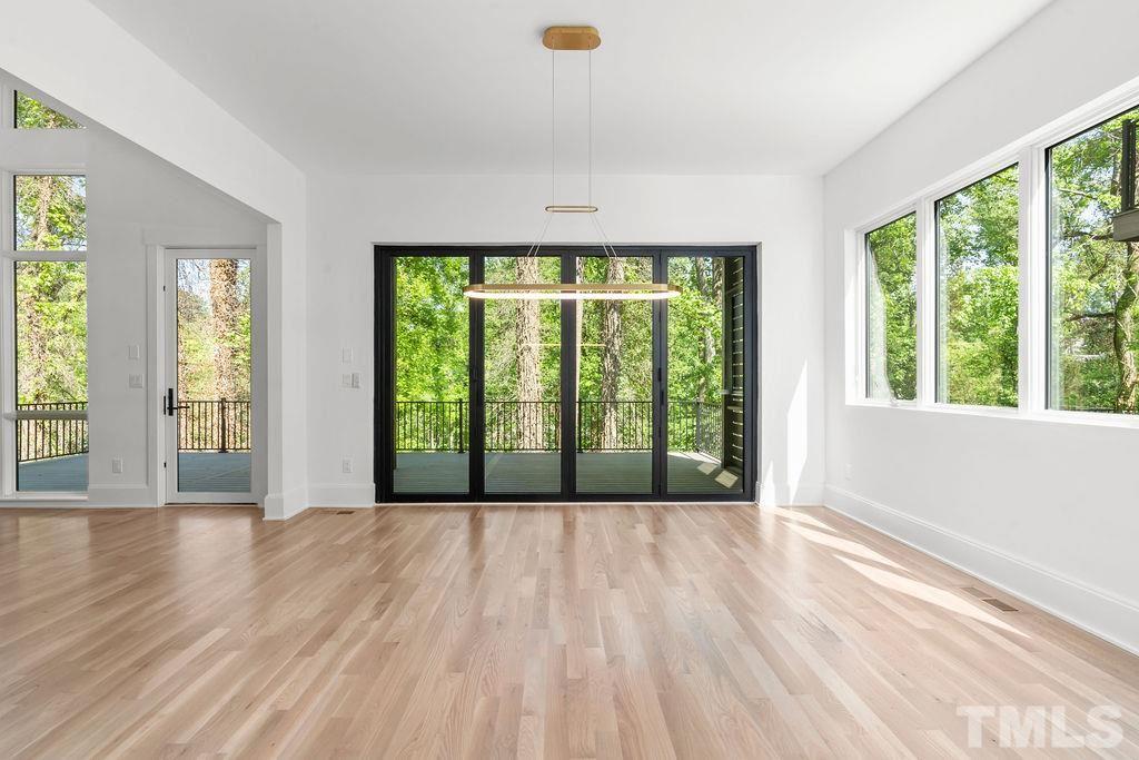 1623 Nottingham Road Raleigh, NC 27607 - Photo 20 of 29 a view of an empty room with wooden floor and a window