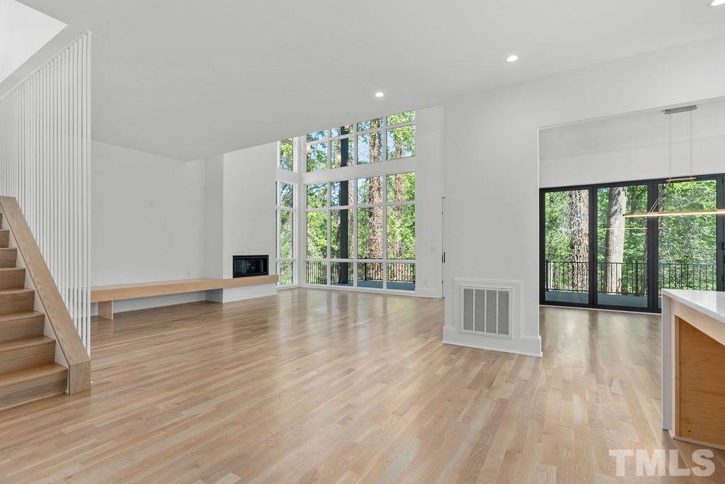 1623 Nottingham Road Raleigh, NC 27607 - Photo 3 of 29 a view of an empty room with wooden floor and a window