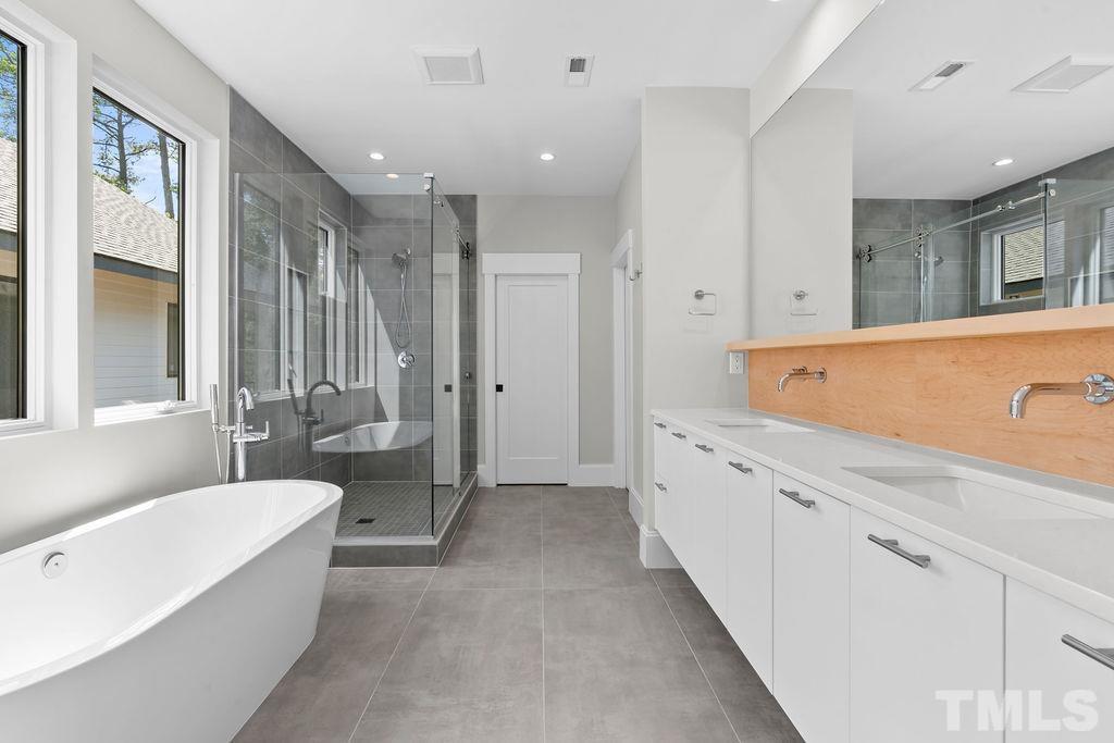 1623 Nottingham Road Raleigh, NC 27607 - Photo 8 of 29 a spacious bathroom with a tub a sink and mirror
