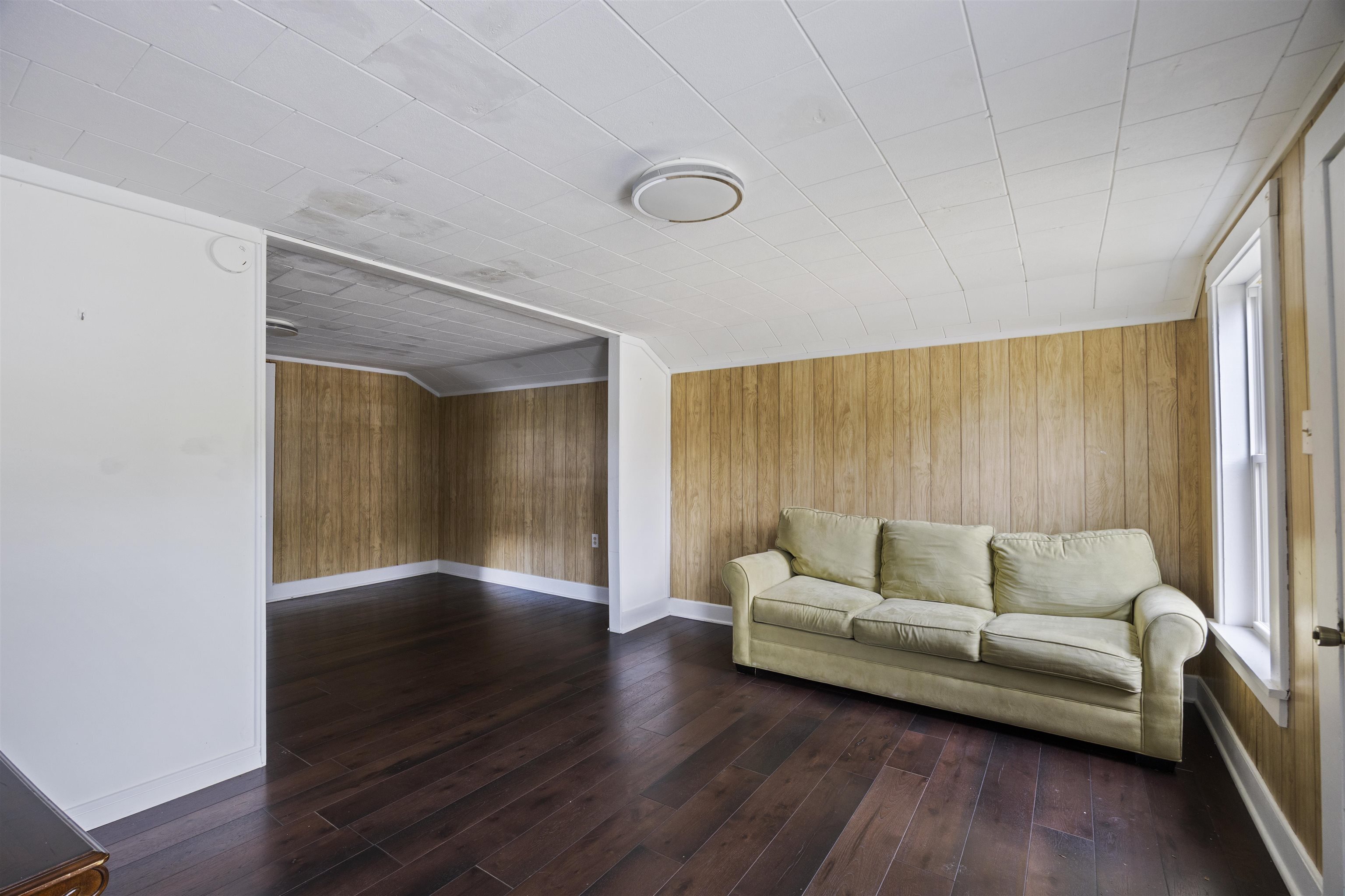 112 South Juniper Street Foley, AL 36535 - Photo 13 of 64 Living area with wooden walls and dark wood-type flooring