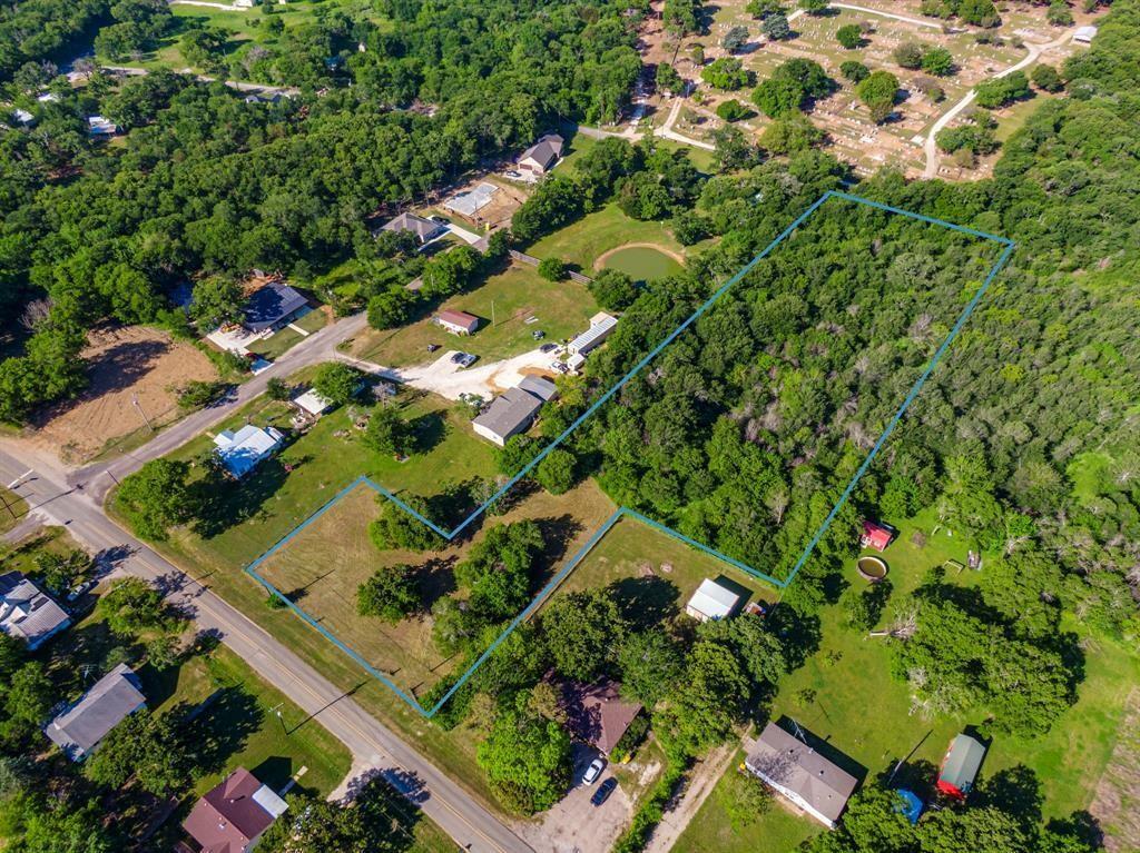 an aerial view of a residential houses with yard
