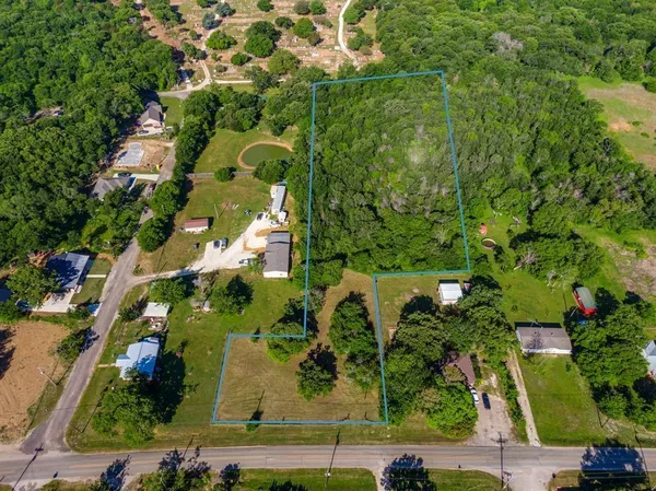 an aerial view of a residential houses with yard