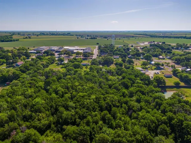 an aerial view of a residential houses with outdoor space