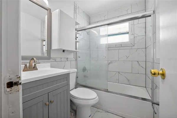 a bathroom with a sink toilet and shower