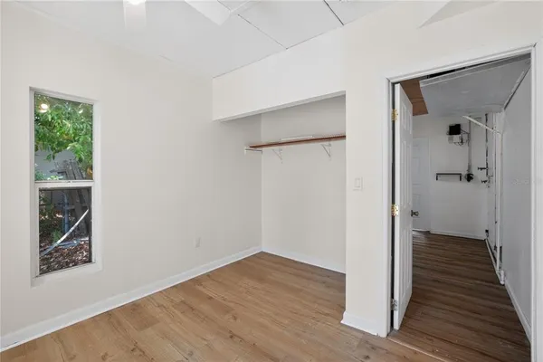 a view of a hallway with wooden floor and entryway