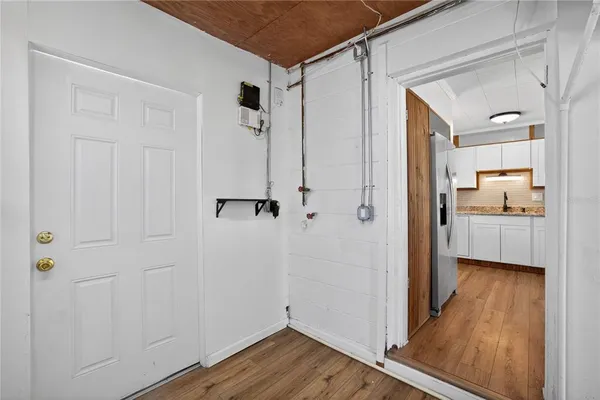 a view of a bathroom with a sink wooden floor and a bathroom
