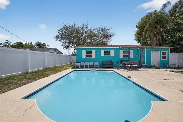 a view of a house with pool yard and outdoor seating