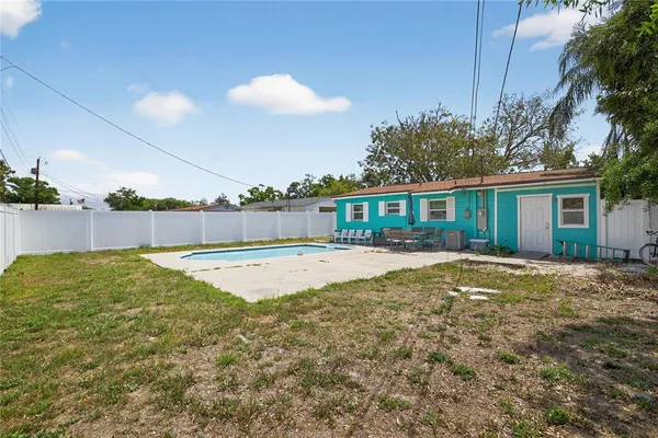 a view of a house with swimming pool and sitting area
