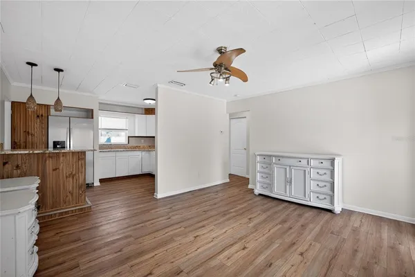 a view of a kitchen with a sink wooden floor and a window