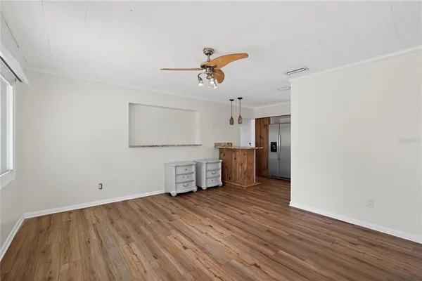a view of a kitchen with wooden floor a sink and a window