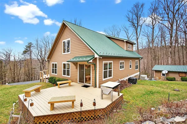 a view of house with yard and outdoor seating