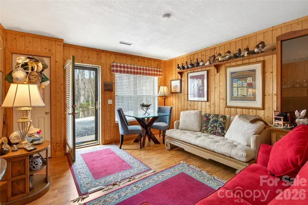 a living room with furniture red walls and a table