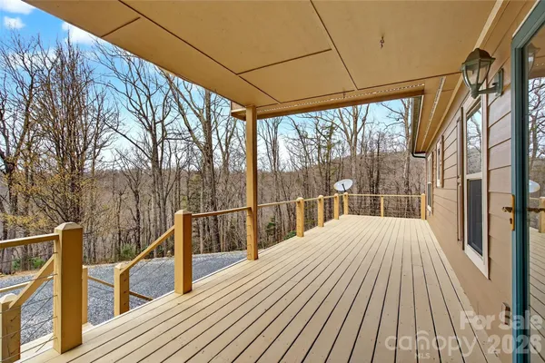 a view of balcony with wooden floor and fence