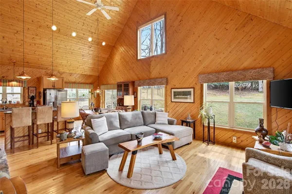 a living room with fireplace furniture and a large window