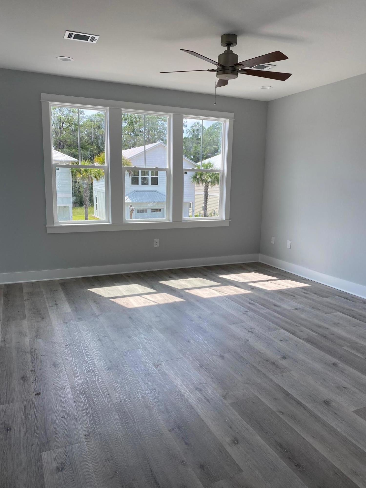 Lot #16 Lighthouse Pointe Boulevard Santa Rosa Beach, FL 32459 - Photo 13 of 23 an empty room with wooden floor and windows