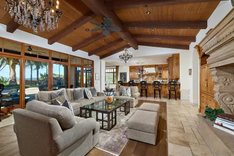 a living room with furniture and a ceiling fan