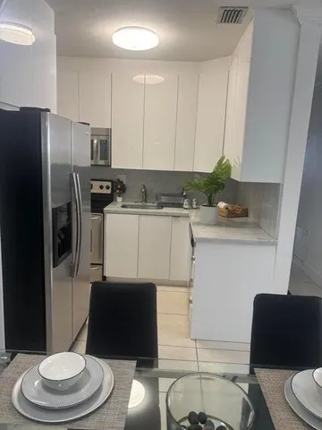 a kitchen with a refrigerator and a stove